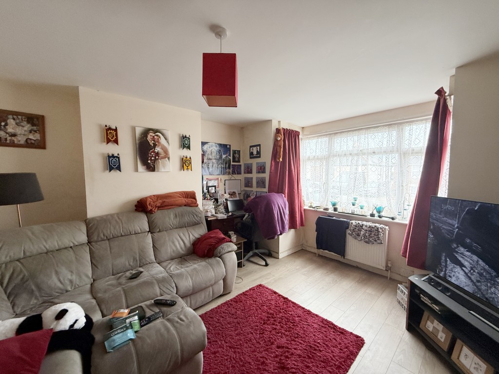 Lot: 156 - FREEHOLD HOUSE FOR INVESTMENT - Living room with bay window and laminate floor